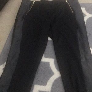 Black pants with leather sides and gold zippers